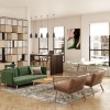 Green sofa, two light brown chairs, large mirrors, and white wall in a stylish living room setting.