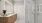 Bathroom featuring a long vanity with wood cabinets, a large backlit mirror, and a walk-in glass shower with white subway tiles